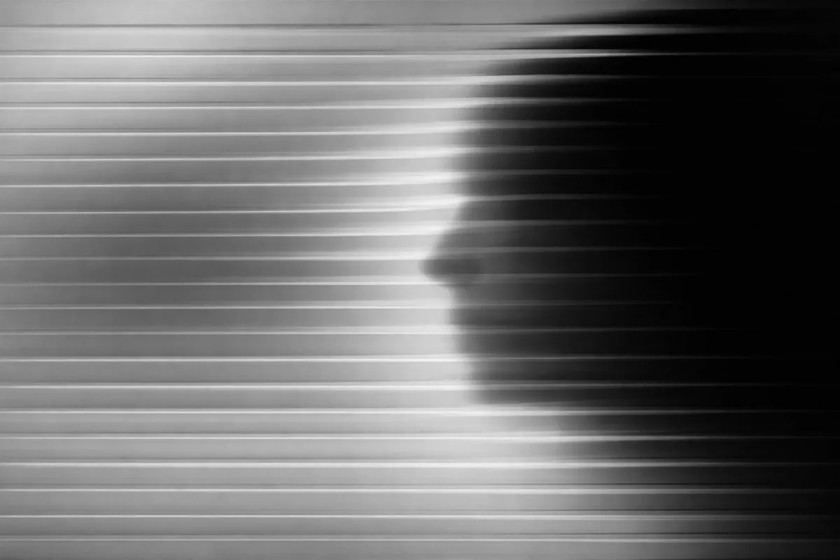 A human profile dissolving into signal lines